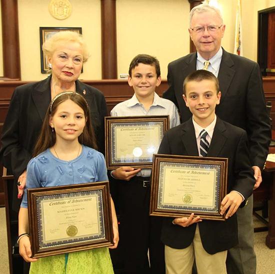 Freeholder Lillian G. Burry presented certificates to the three student essay award winners with Glenn Cashion of the Monmouth County Historical Commission. Pictured left to right: Freeholder Lillian G. Burry, Madeleine Hicks, St. Leo the Great School; Ryan Guss, Oak Hill Academy; David Burrell, Oak Hill Academy and Commissioner Glenn Cashion.